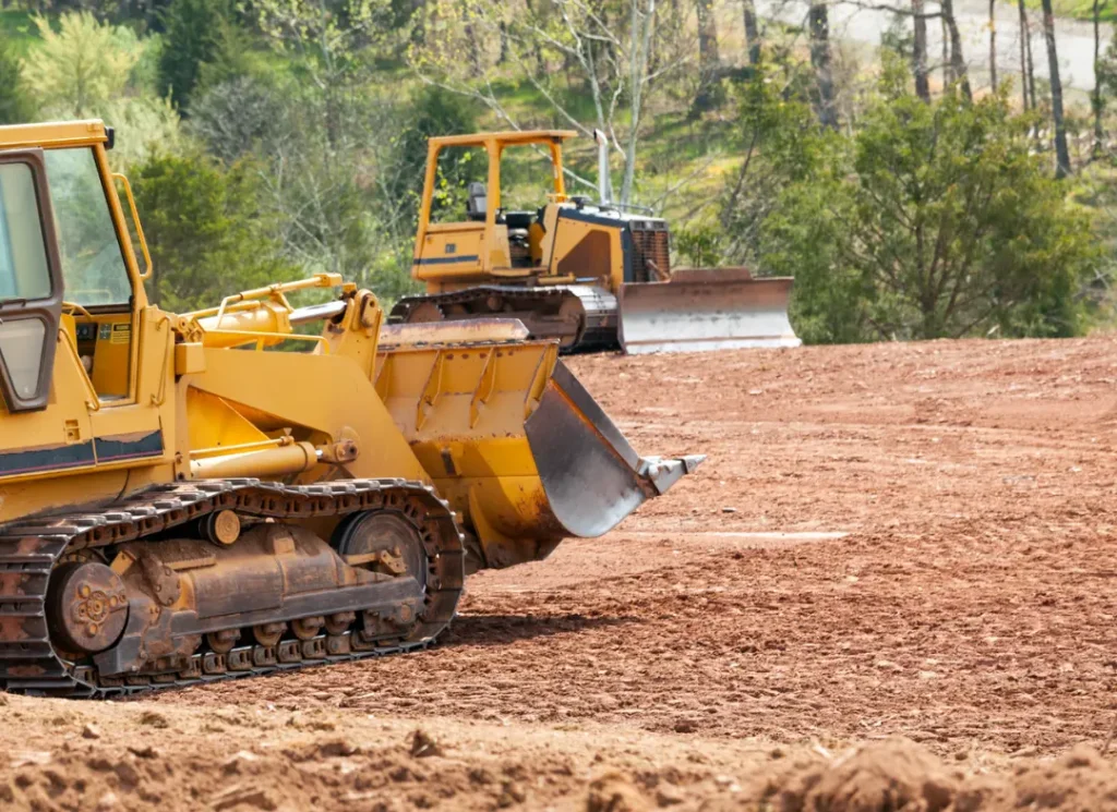 Bulldozers grading red soil